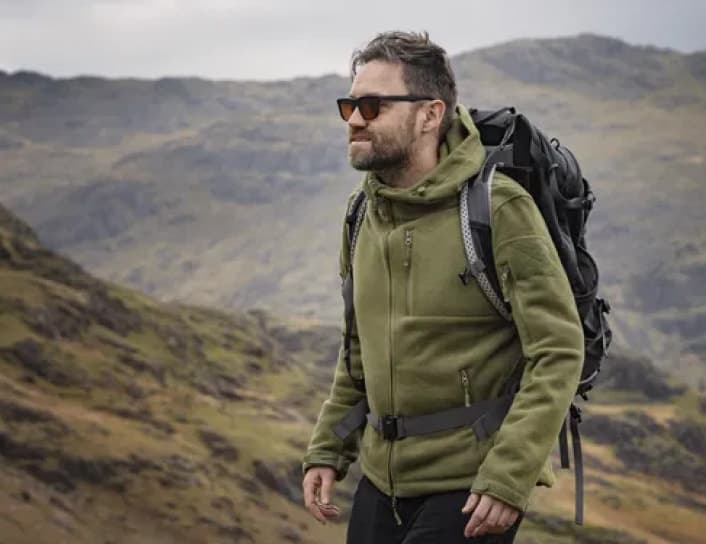Hiker with backpack on hillside