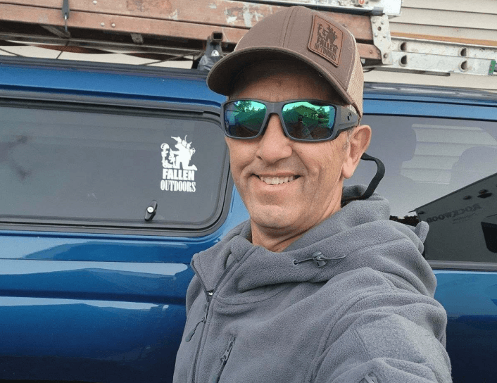 Man on cliff overlooking lake